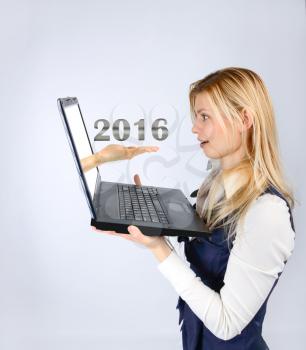 Business woman holding a laptop and 2016. business planning and concept