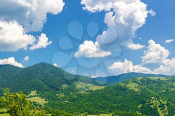 Mountain valley on a background of cloudy sky. Summer landscape