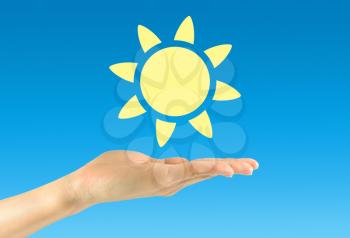 Solar energy concept. Icon sun in a man's hand