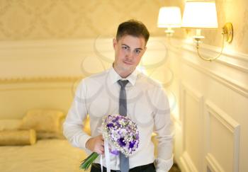 Concept of feelings and emotions. Elegant young man with a bouquet of flowers