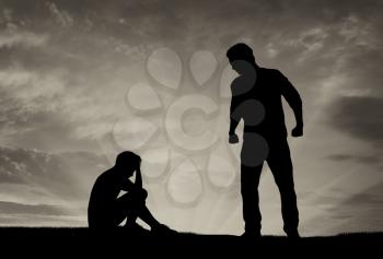 Child abuse and bullying. Silhouette of a crying boy and aggressive father