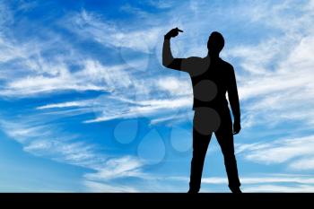 A silhouette of a narcissistic man shows his finger at himself. He tries to attract attention. The concept of narcissism and selfishness