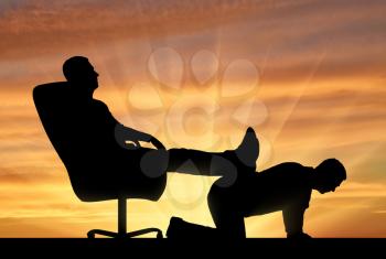 Silhouette of a selfish man sitting in a chair, threw back his legs on the back of a man. The concept of discrimination and inequality