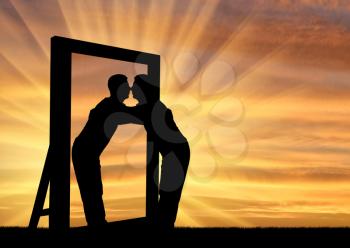 Silhouette of a narcissistic man hugging his reflection in a mirror. The concept of narcissism and selfishness