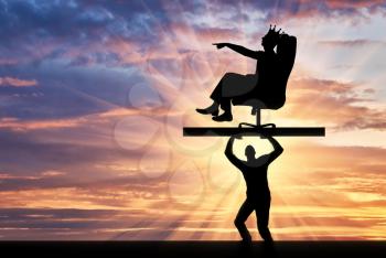 The silhouette of a selfish man with a crown on his head sitting in a chair, points to another man who carries it, where to move. The concept of selfish behavior towards other people