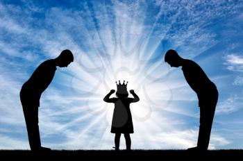 Selfish little girl with a crown on her head and two servants worship her. Concept of selfish and narcissistic children