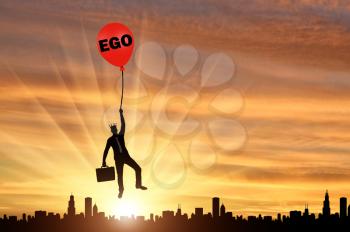 Selfish businessman holding on to a balloon called the ego soaring above the city. Conceptual scene of a narcissistic and selfish businessman