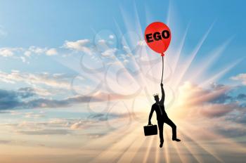 Selfish businessman holding on to a balloon called the ego. Conceptual scene of a narcissistic and selfish businessman