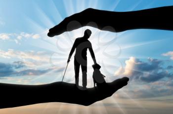 Silhouette of a blind disabled man with a cane in his hand and a dog guide. The concept of protection and assistance to blind disabled people