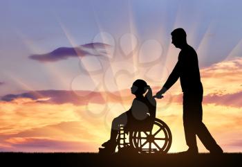 Silhouette of a disabled child girl sitting in a wheelchair and her dad on a walk. The concept of helping and caring for children with disabilities