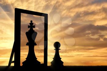 Silhouette of a pawn, sees himself in the reflection of the mirror queen. The concept of narcissism and ego