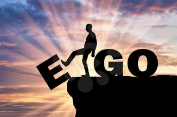 Silhouette of a man gets rid of the ego as a bad habit. Conceptual image of the fight against egoism