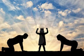 Silhouette of a child girl with a crown on her head and parents worshiping her. Conceptual image of childish egoism