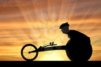 Silhouette of sportsman disabled in a racing wheelchair. The concept of disabled sportsmen