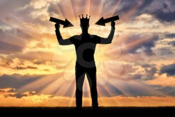 Silhouette of a selfish man with a crown on his head tries to attract attention by holding pointer in his hands. The concept of a selfish and narcissistic personality
