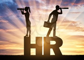 Hiring concept. A silhouette of a man and a woman stand on the letters HR and look through binoculars in search of potential employees