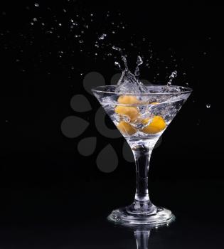 Vermouth cocktail inside martini glass over dark background