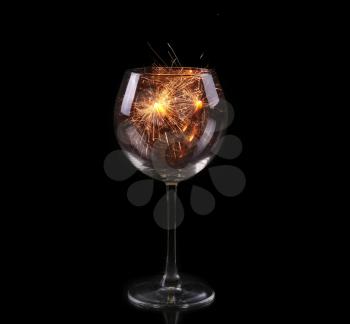 Wine glass with a sparkler. In anticipation of New Year and Christmas