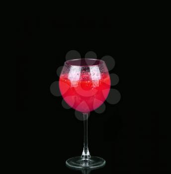 Cosmopolitan cocktail in nice red color in front of a black background