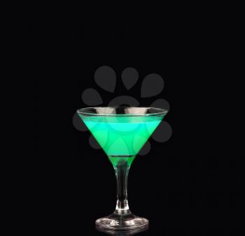 Martini glass with green coctail on black background