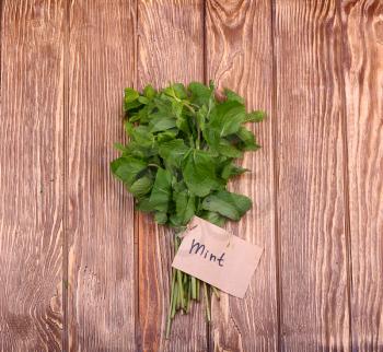 Bunch of mint on the boards, wooden background