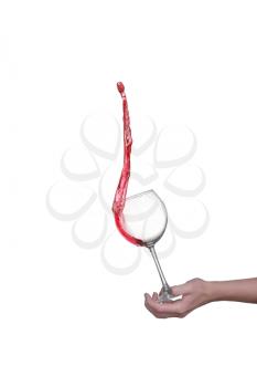 Red wine splashing from glass, isolated on white background