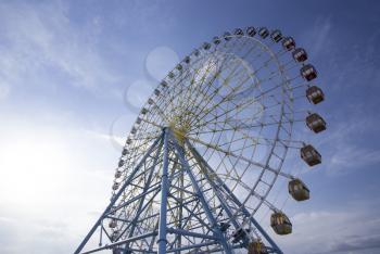 Ferris Wheel Over Blue Sky. Ferris wheel joy sky clouds. Park
