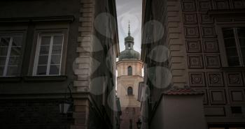 A view of the ancient tower from the alley. Warsaw, the old city. Heart of history