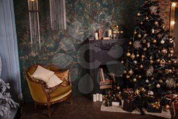 Decorated Christmas room with beautiful fir tree. Black and Gold