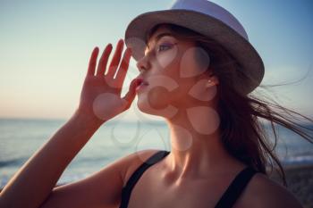 Asian woman wearing fashion straw beach hat for skin care sun protection. Face skincare beauty concept. Beautiful Chinese Caucasian mixed race young adult girl portrait on summer vacation travel.
