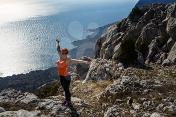 young fitness woman trail runner on sunrise seaside trail. Crimean mountains. Idea and concept of freedom and rest