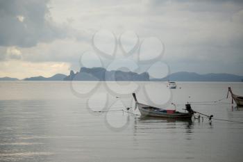 Traditional thai boats at sea. Krabi province. Low tide and silence