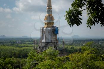 The top of Tiger Cave temple, Wat Tham Suea , Krabi region, Thailand. At the top of the mountain there is a large golden Buddha statue which is a popular tourist attraction.