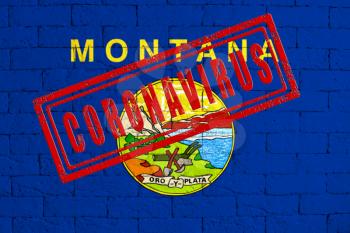 Flag of the State of Montana painted on grungy brick wall background. with stamp CORONAVIRUS, idea and concept of healthcare, epidemic and disease in USA