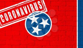 Flag of the State of Tennessee painted on grungy brick wall background. with stamp CORONAVIRUS, idea and concept of healthcare, epidemic and disease in USA