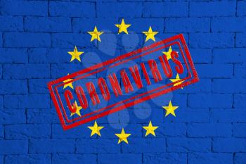 Flag of the EU or European Union on brick wall texture. stamped of Coronavirus. Corona virus concept. On the verge of a COVID-19 or 2019-nCoV Pandemic. Novel Chinese Coronavirus outbreak