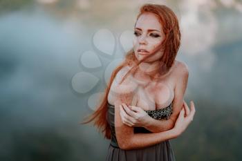 beautiful furious scandinavian warrior ginger woman in grey dress with metal chain mail. Woman is a Viking. Fantasy. Book Cover. Close-up portrait. Cinematic look