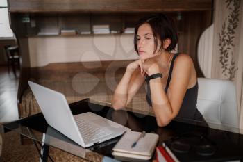 Thoughtful doubtful asian female student worker looking away thinking solving problem feel lack of new creative ideas at work, pensive puzzled or bored young woman sit at desk with laptop