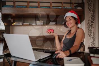 Attractive asian woman holding a credit card and shopping on a laptop. Christmas online shopping, sales and discounts promotions during holidays, online shopping at home and lockdown coronavirus.Xmas