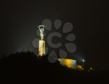 Night shot of the illuminated Freedom or Liberty Statue on Gellert Hill in Budapest, Hungary
