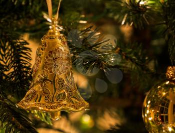 Macro images of xmas decoration on Christmas tree illuminated by lights