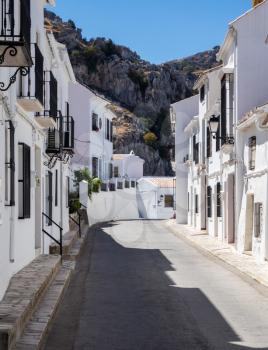 Narrow street in white painted hill town of Zuheros in Andalucia in Southern Spain