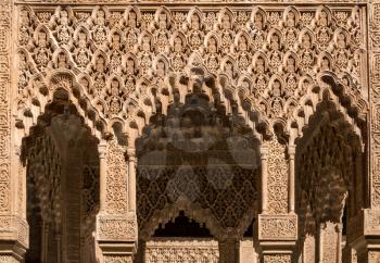 Repeated ornate carved arch in courtyard of Alhambra palace Granada, Spain