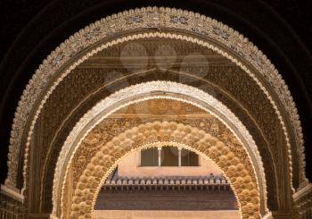 Repeating series of arabic or islamic arches with courtyard of Alhambra palace in Granada Spain