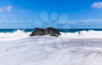 Dramatic powerful waves crash over rocks on dangerous beach at Lumaha'i, Kauai, Hawaii