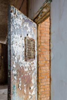 Metal barred door leading to cell inside Trans-Allegheny Lunatic Asylum in Weston, West Virginia, USA