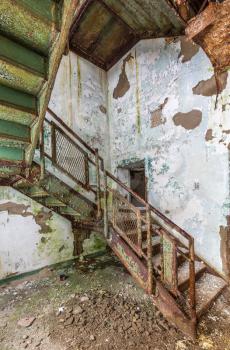 Stairs and cast iron rails inside Trans-Allegheny Lunatic Asylum in Weston, West Virginia, USA