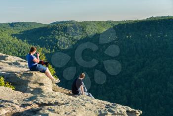 Hikers look at Cheat River Canyon from Raven Rock in Coopers Rock State Forest West Virginia