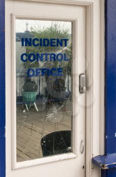 Security office or incident control office doorway with broken mirrored glass window