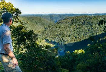 Senior adult hiker overlooks the Cheat River Canyon from Snake River Wildlife Management Area near Morgantown in West Virginia